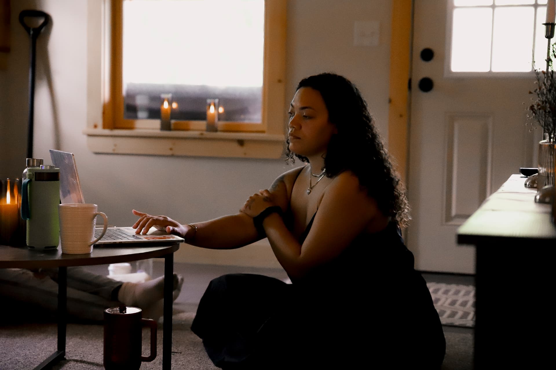 A quiet moment of reflection on the floor beside candlelight during a retreat