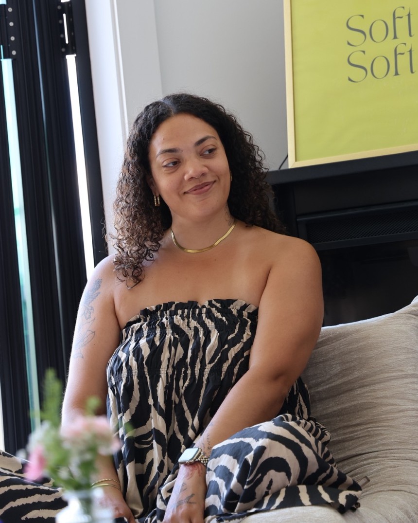 Tiana seated in a soft, sunlit room
